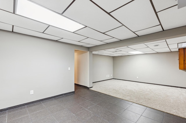 basement with a paneled ceiling