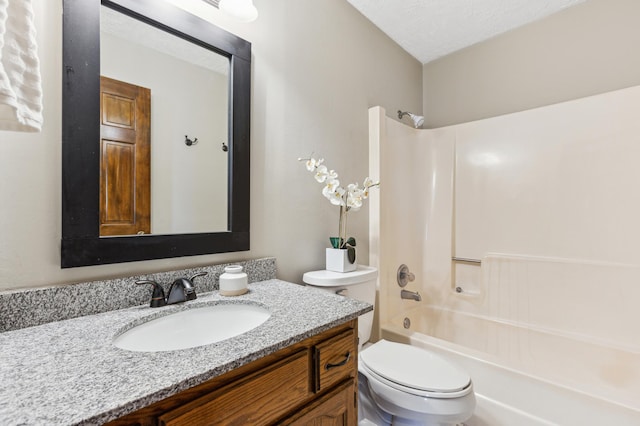 full bathroom with shower / washtub combination, toilet, vanity, and a textured ceiling