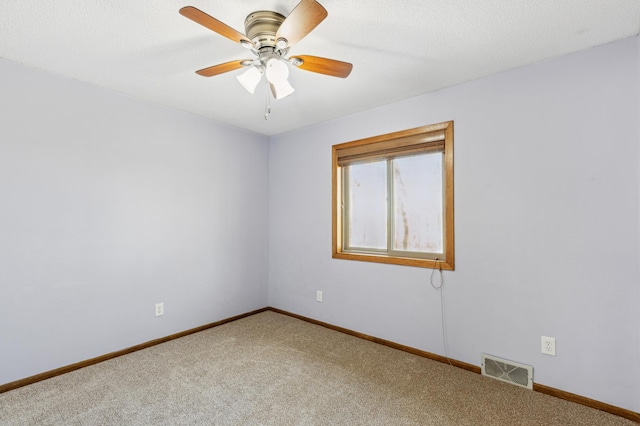 unfurnished room featuring ceiling fan, carpet, and a textured ceiling