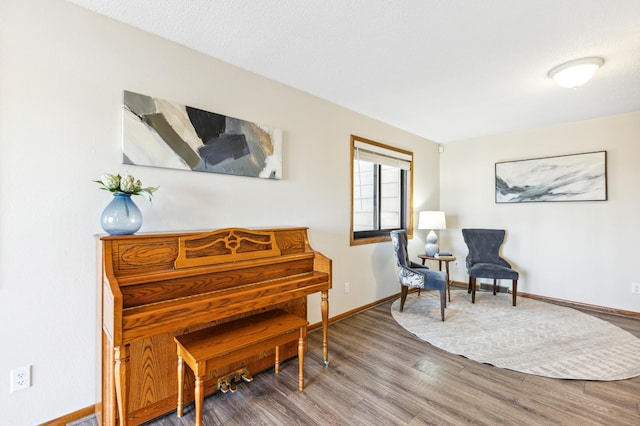 sitting room with hardwood / wood-style flooring