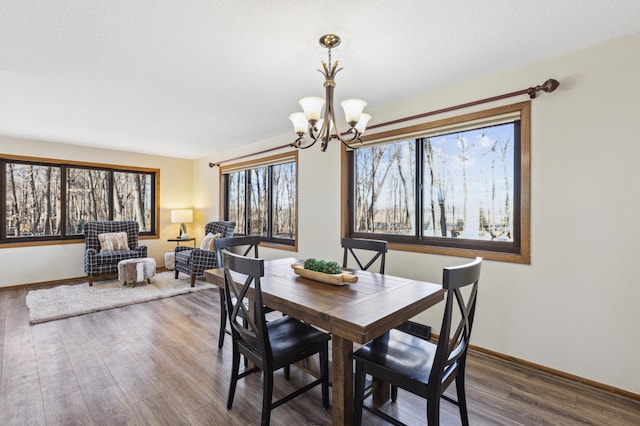 dining room featuring hardwood / wood-style flooring, a chandelier, and a textured ceiling