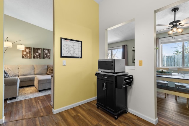 hall with baseboards and dark wood-style floors