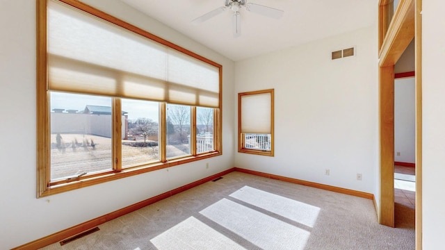 empty room featuring visible vents, baseboards, and carpet