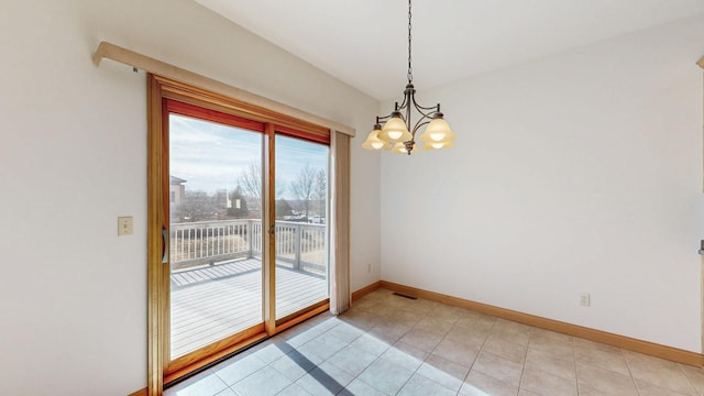 empty room with light tile patterned floors, visible vents, an inviting chandelier, and baseboards