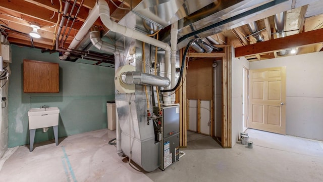 utility room with a sink and heating unit