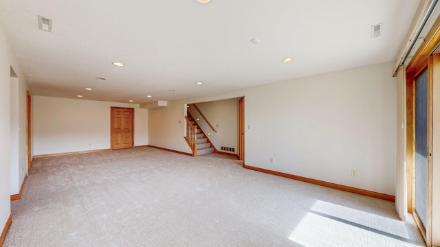 interior space with stairway, light carpet, recessed lighting, and visible vents