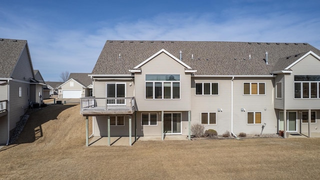 rear view of property with a lawn and central air condition unit