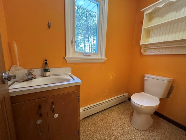 bathroom featuring vanity, toilet, and a baseboard heating unit