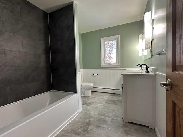 full bathroom featuring vanity, tiled shower / bath, a baseboard radiator, and toilet