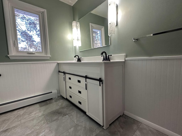 bathroom with vanity and a baseboard heating unit