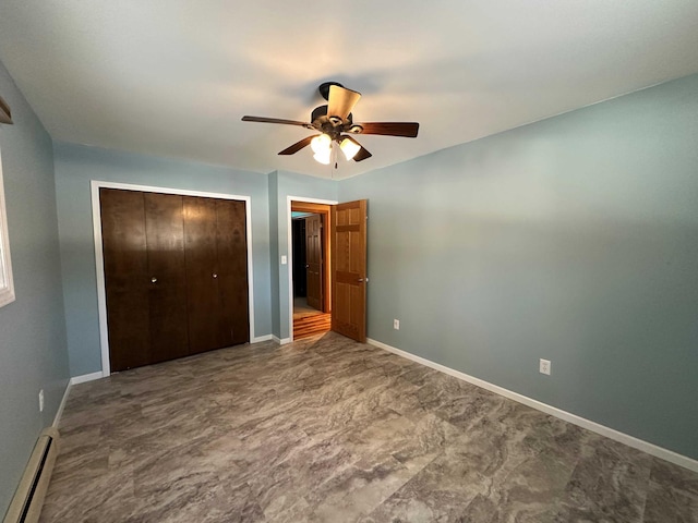 unfurnished bedroom featuring ceiling fan, baseboard heating, and a closet