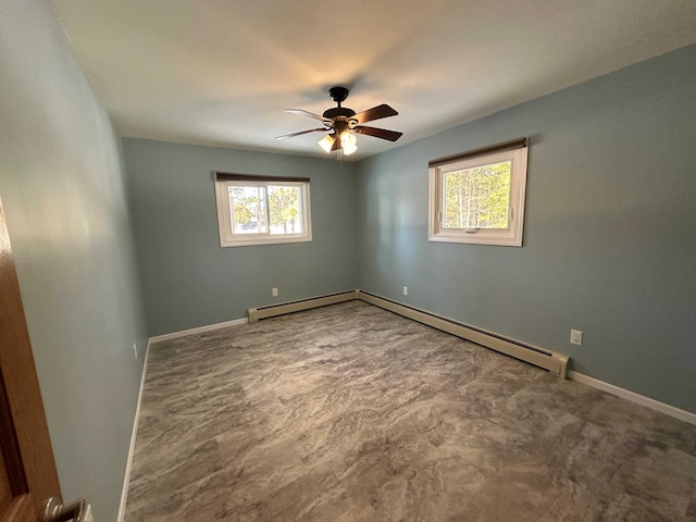 spare room featuring a baseboard heating unit and ceiling fan