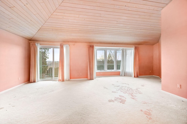 interior space with vaulted ceiling, light colored carpet, and wooden ceiling