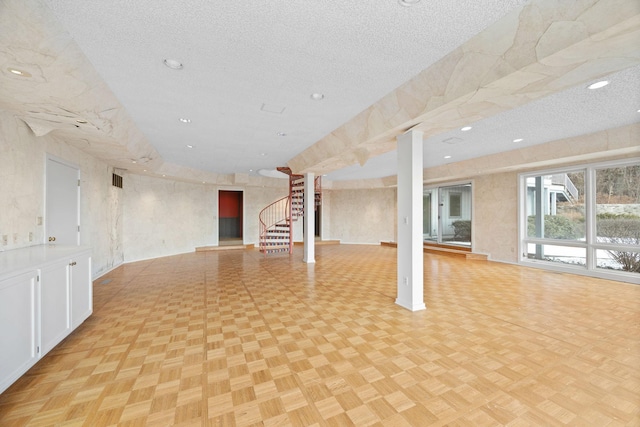 interior space featuring stairs, a textured ceiling, and recessed lighting