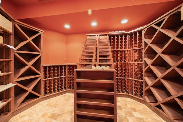 wine room with stone finish flooring, visible vents, and recessed lighting