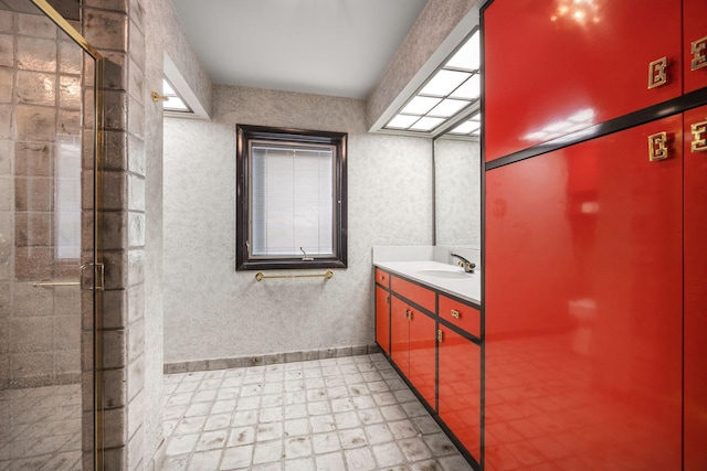 full bathroom featuring tiled shower and vanity