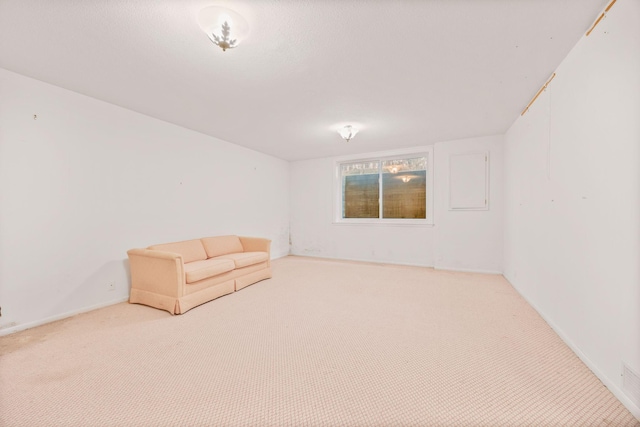 unfurnished room featuring carpet floors and baseboards