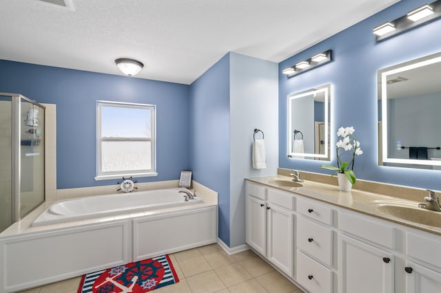 bathroom with a bath, a shower with shower door, a sink, and tile patterned floors