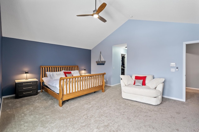 bedroom with carpet, vaulted ceiling, a spacious closet, and baseboards