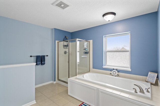 full bath featuring a garden tub, tile patterned flooring, visible vents, baseboards, and a shower stall