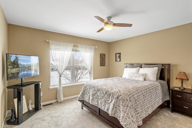 bedroom featuring carpet flooring, ceiling fan, visible vents, and baseboards