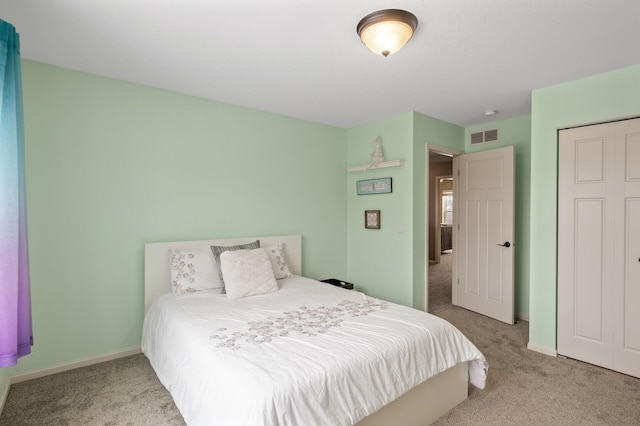 bedroom featuring carpet, a closet, visible vents, and baseboards