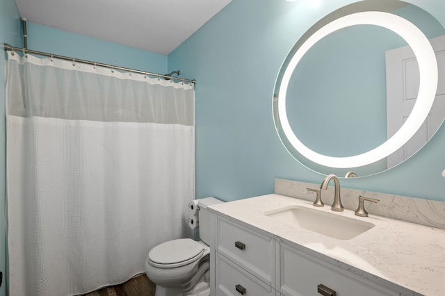 full bath featuring curtained shower, vanity, and toilet