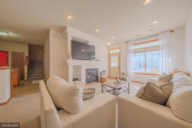 carpeted living room featuring a textured ceiling