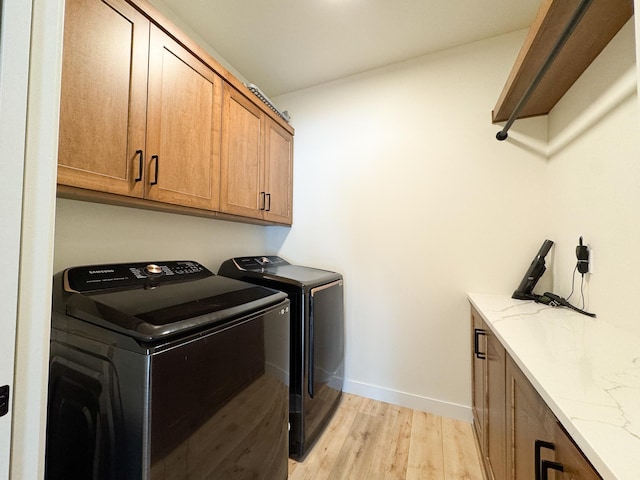 106 19th St NE, Barnesville, MN 56514 - washroom featuring cabinet space, washing machine and clothes dryer, and light wood-style flooring