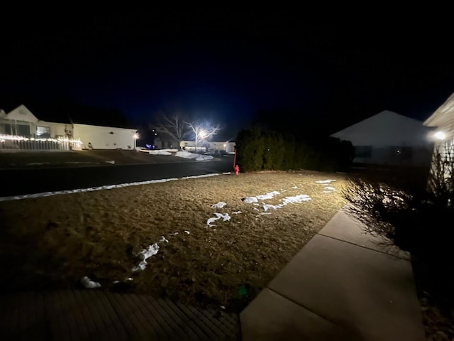 view of yard at twilight