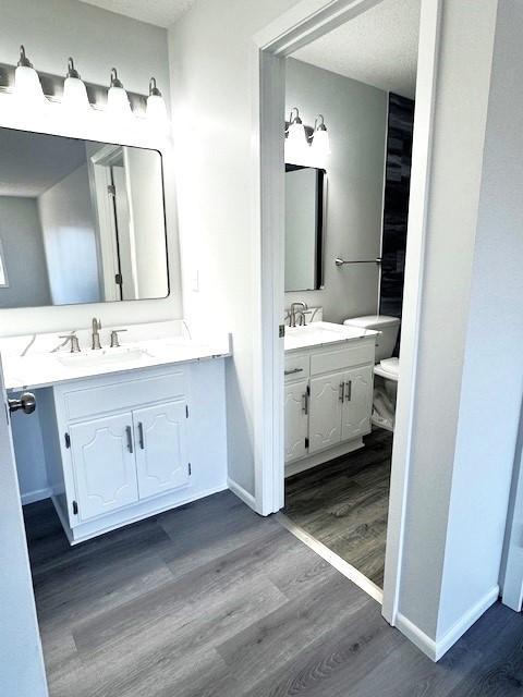 bathroom featuring vanity, hardwood / wood-style floors, and a textured ceiling