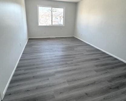 spare room featuring dark wood-type flooring