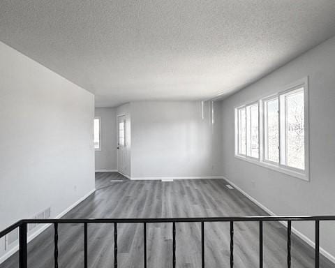 spare room with hardwood / wood-style flooring and a textured ceiling