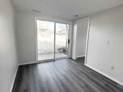 spare room with dark hardwood / wood-style floors