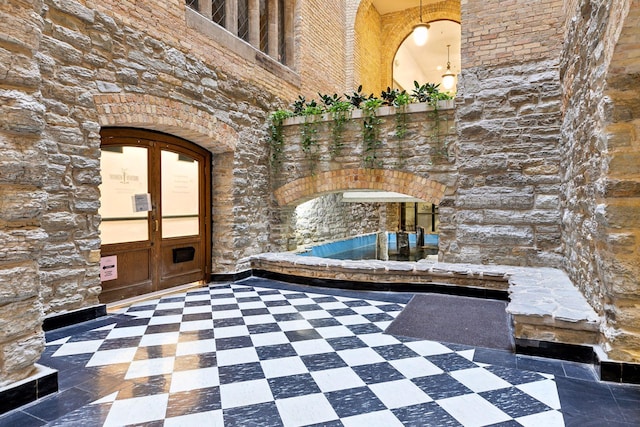 bathroom featuring french doors and a high ceiling