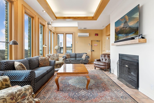 living room with a raised ceiling and a wall mounted AC