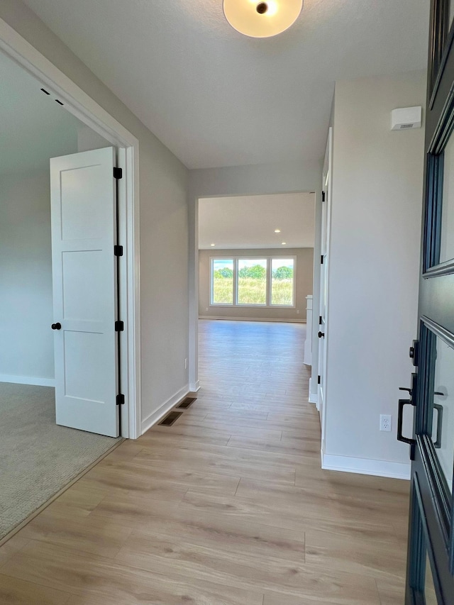 corridor featuring light hardwood / wood-style floors