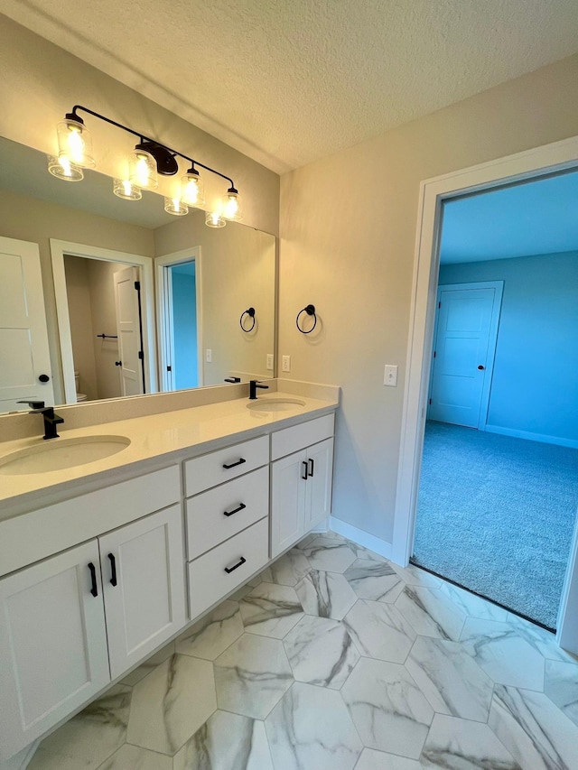 bathroom with vanity and a textured ceiling