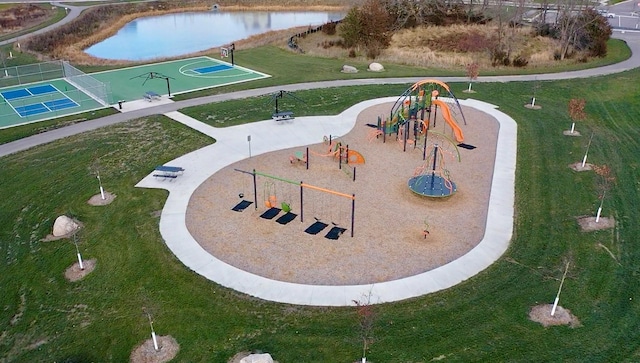 view of community featuring a playground, a water view, and tennis court