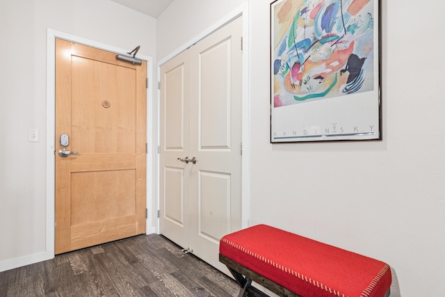 foyer entrance with baseboards and dark wood finished floors