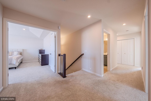 hallway with light colored carpet