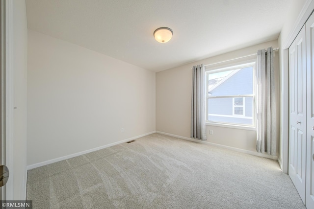 spare room with light colored carpet