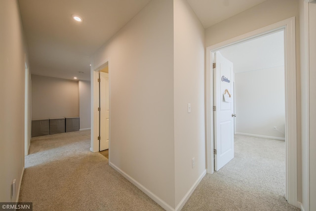 hallway featuring light carpet