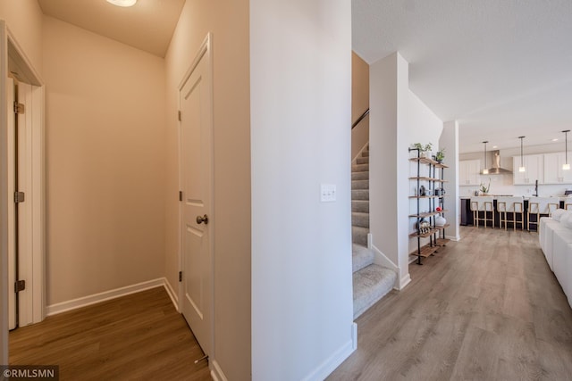 corridor with hardwood / wood-style floors