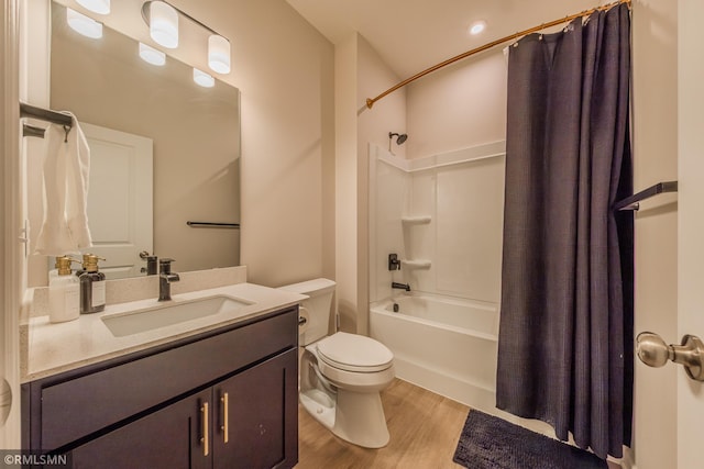 full bathroom with hardwood / wood-style flooring, vanity, shower / bathtub combination with curtain, and toilet