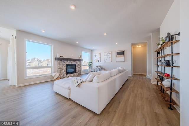 living room with a fireplace and light hardwood / wood-style floors