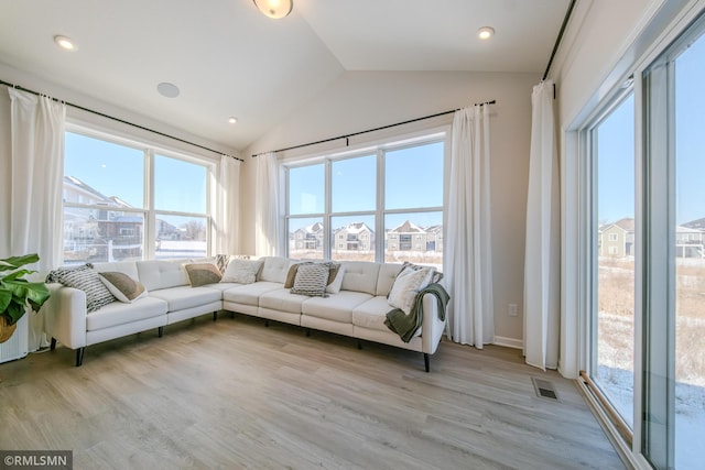 living room with lofted ceiling and light hardwood / wood-style flooring