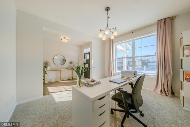 office area with a chandelier and light carpet