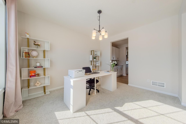 carpeted office with a notable chandelier