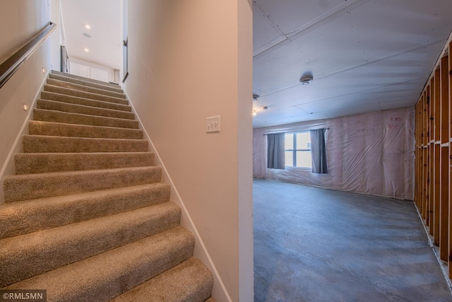 staircase featuring concrete flooring